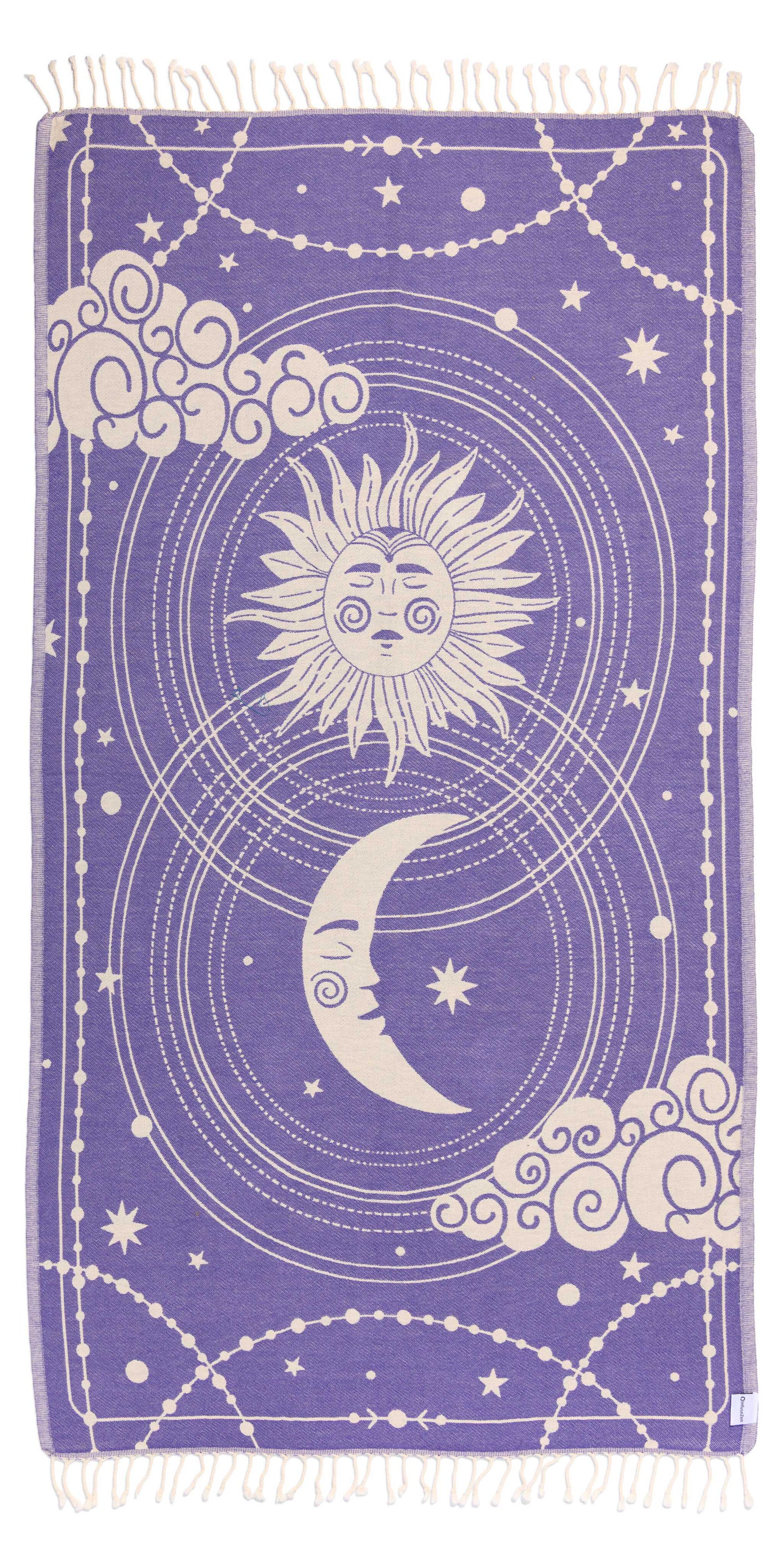 Towel with celestial design featuring sun, moon, and stars on a purple background