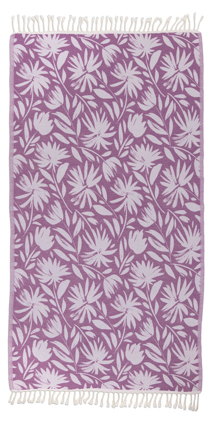 Floral patterned towel with white leaves on a purple background